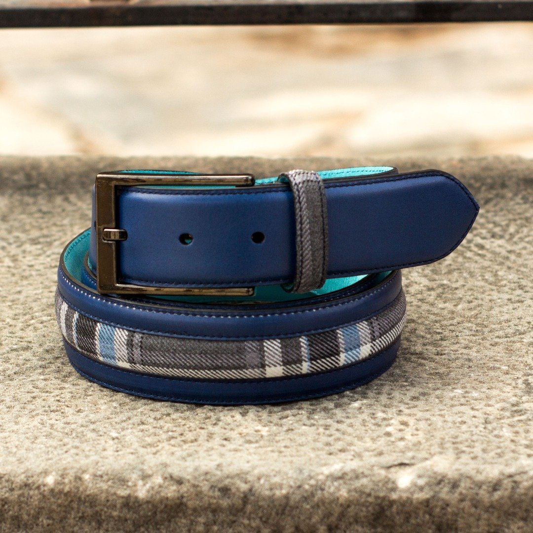A unique mix of navy leather and plaid fabric. This belt features a bright turquoise lining and a versatile design that works with any outfit. Handcrafted just for you and delivered in 2 to 4 weeks.